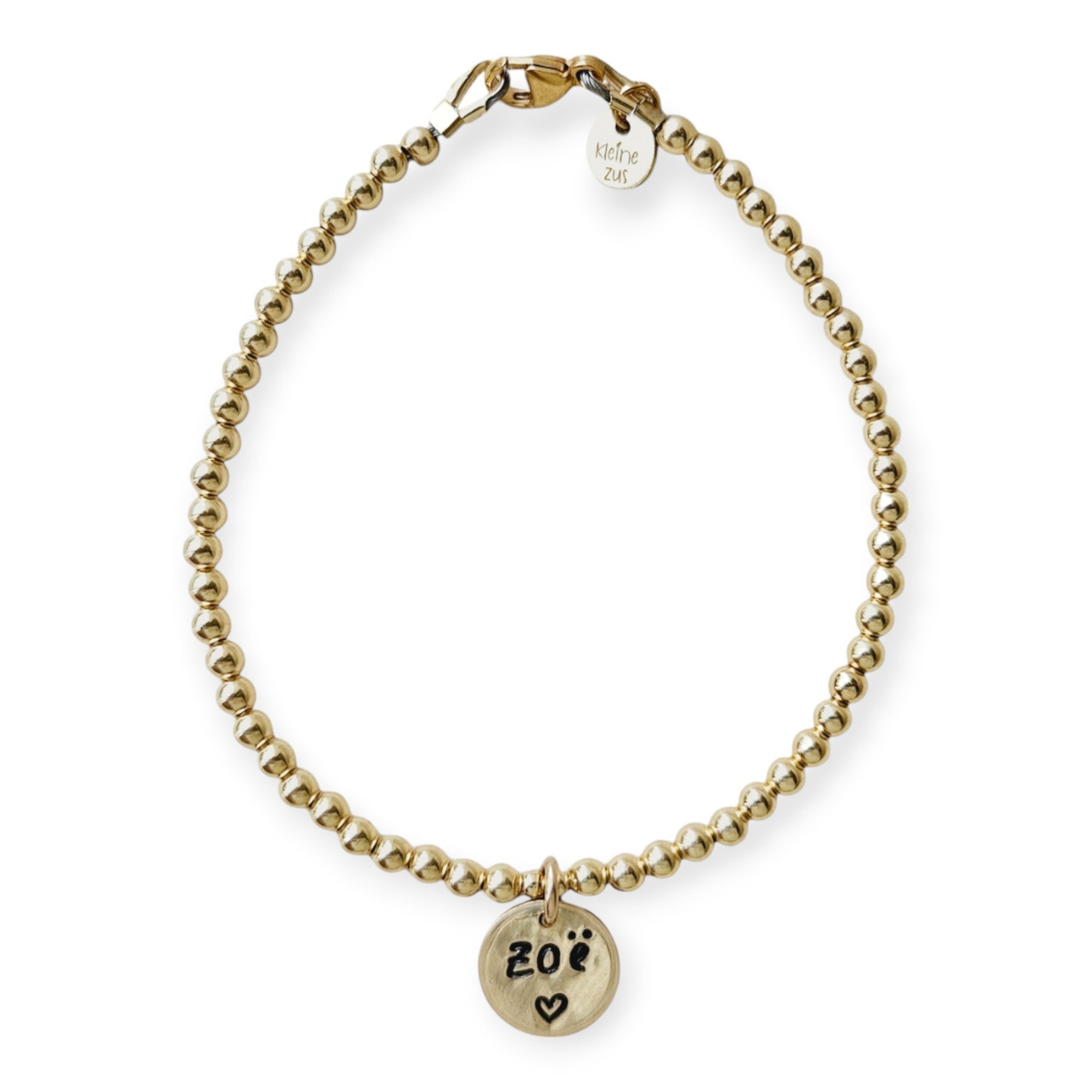 Armband met naam dames goud Juul
3mm gouden kraaltjes, in het midden hangt een gouden naambedel van 10mm