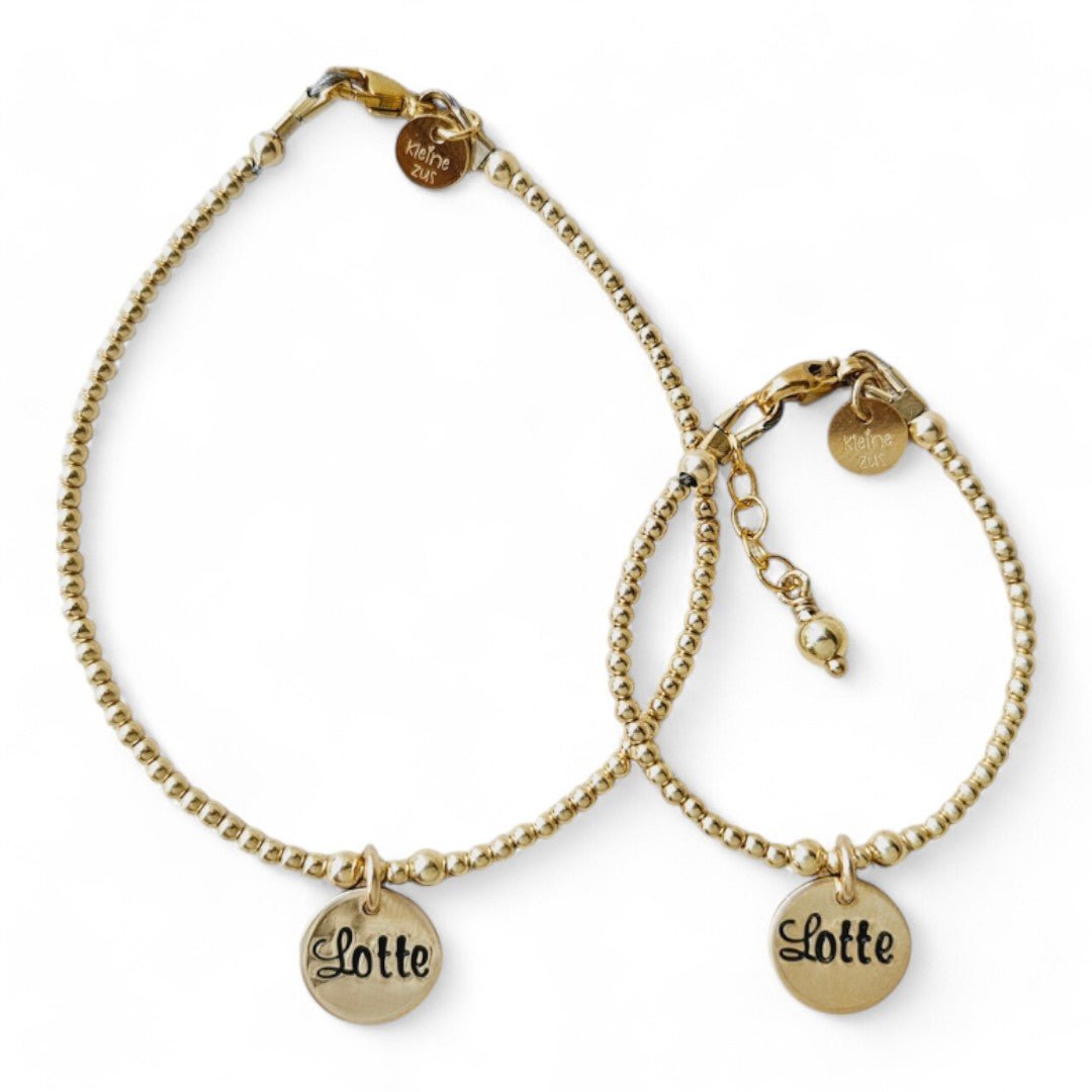 moeder dochter armband goud Lieve met 2mm kraaltjes, in het midden hangt een gouden naambedeltje van 10mm